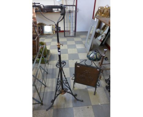 An Arts and Crafts wrought iron and copper fire screen and standard lamp