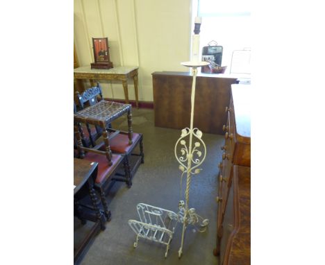 A painted wrought iron standard lamp and matching paper rack