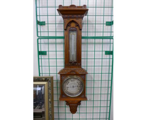 A Victorian walnut aneroid barometer