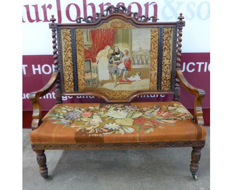 A Victorian rosewood settee upholstered with tapestry panel back and seat