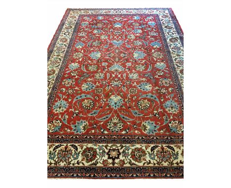 PERSIAN ISFAHAN CARPET, 320cm x 210cm, of turquoise scrolling leaves and palmettes on ruby field.