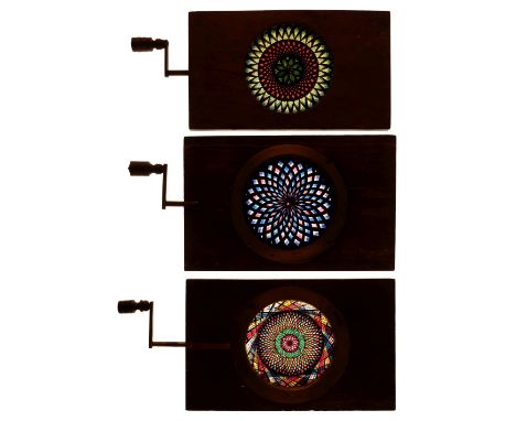 * Magic Lantern Slides. A group of 4 hand-painted kaleidoscopic chromotropes with single turning handles (one missing), toget