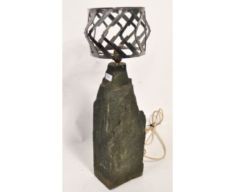 A large heavy stone and cut polished steel table lamp. Heavy stone fragment base with applied bulb mount and set with a chevr