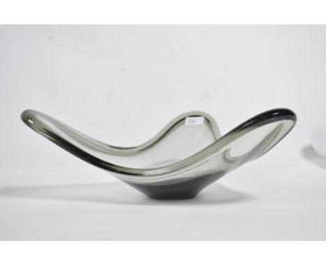 Per Lutken ( 1916-1998 ) for Holmegaard: a clear glass bowl of irregular circular form with a slight tint signed to the base.