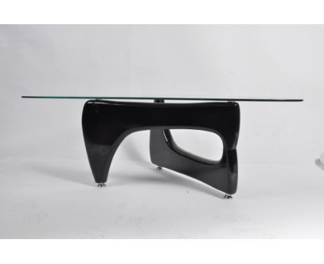 A good contemporary Isamu Noguchi coffee table - occasional table having glass top raised over a tripod shaped ebony resin ca