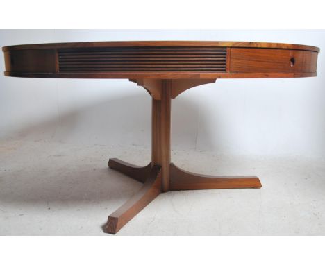 A mid century retro Robert Heritage for Archie Shine large drum shaped dining table. The round top with three frieze drawers 