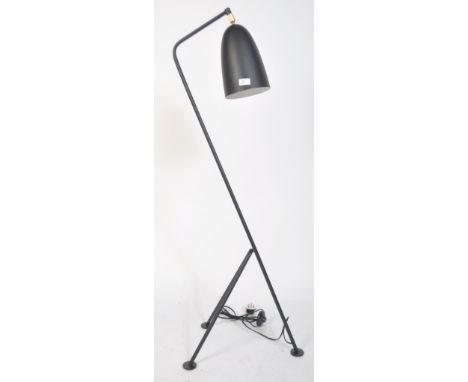 After Greta Grossman, a large black grasshopper floor lamp. Having a tubular steel tripod frame with tilt action having conic