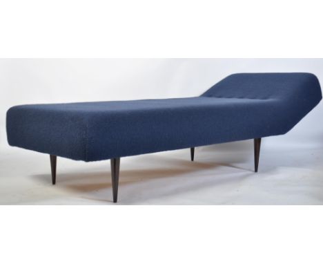 A retro 20th century sofa day bed of large form being raised on angular tapering legs and upholstered in a blue moquette fabr