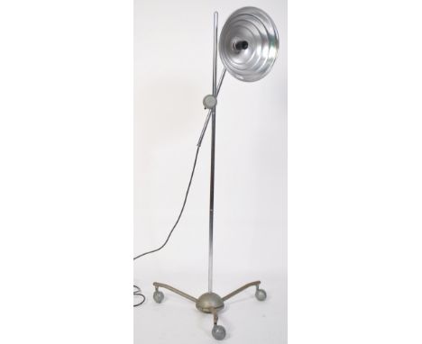 A vintage mid century floor standing adjustable converted heat lamp, having a metal tubular adjustable height frame raised on