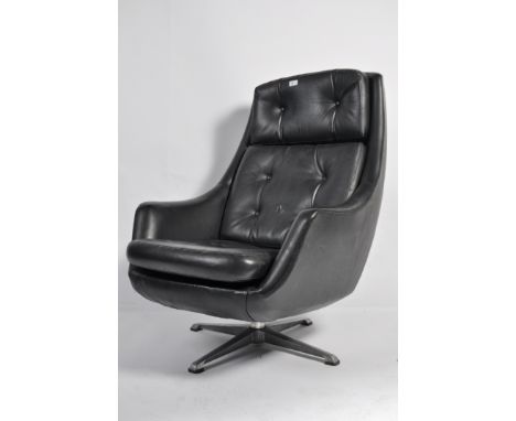 A vintage retro 20th century Danish vinyl upholstered recliner swivel easy chair raised on chromed swivel supports having mak