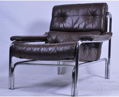 A pair of original 20th century / 1970's Pieff ' Alpha '  armchairs by Tim Bates. The large brown leather and chrome armchair