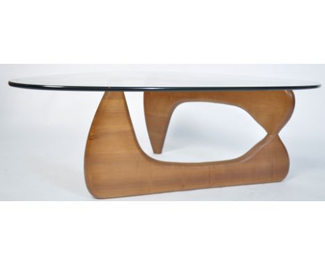 A good contemporary Isamu Noguchi coffee table - occasional table having glass top raised over a tripod shaped teak wood base