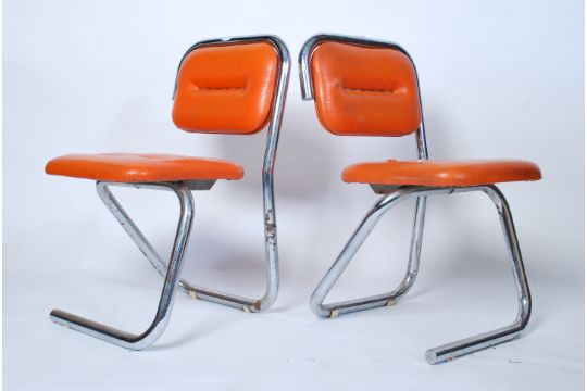 A pair of 1970's retro chrome tubular orange vinyl upholstered dining ...