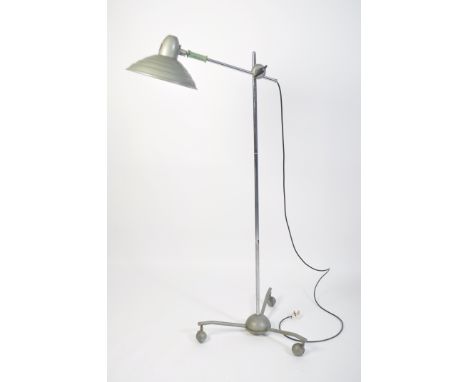 A floorstanding full size Sollux Industrial lamp raised on a spider leg base with ball wheel castors having UFO space age sha