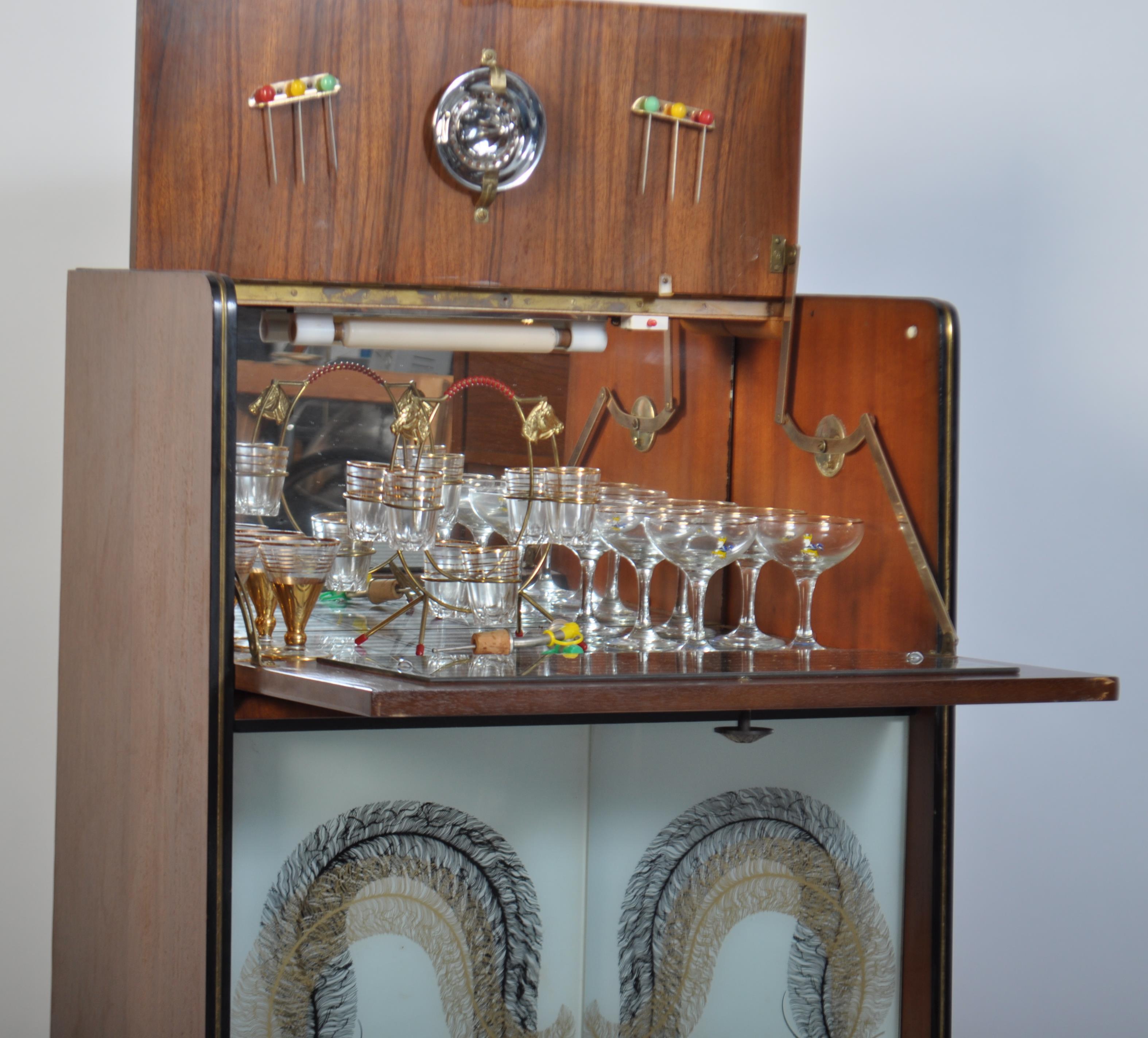 A mid century retro cocktail cabinet having coloured art glass sliding ...