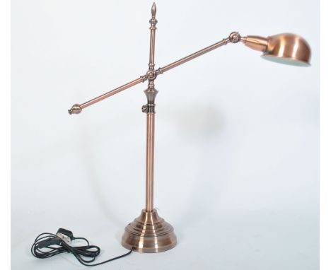 A fabulous polished copper anglepoise desk lamp raised on terraced base with tubular construction with adjustable long arm wi