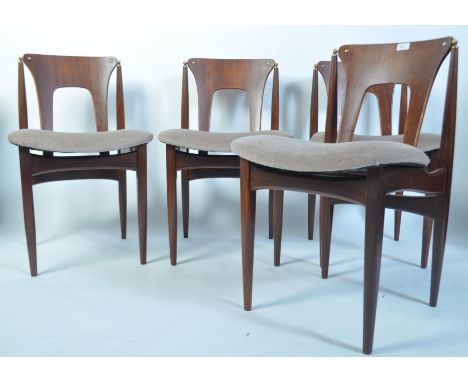 A set of 4 1950's teak dining chairs in the manner of Poul Volther raised on tapered legs with upper peripheral stretchers, s