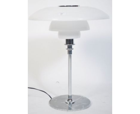 After Poul Henningsen. A stunning PH80 model table lamp having chrome terraced base and support with space aged white glass U