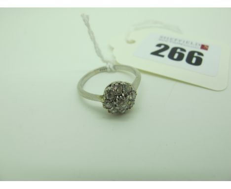 A Vintage Diamond Cluster Ring, of flowerhead design, claw set throughout with old cut stones, stamped "Plat" (finger size M)