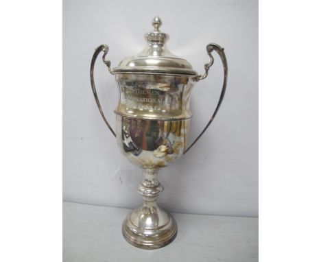 A Large Plated Twin Handled Trophy Cup and Cover, engraved "The Van Diemen International Challenge", with pull off cover, on 