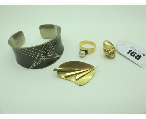 Two Modernist Style Dress Rings, each of stylised design (stamped marks); together with a Jorgen Jensen Danish Pewter cuff ba