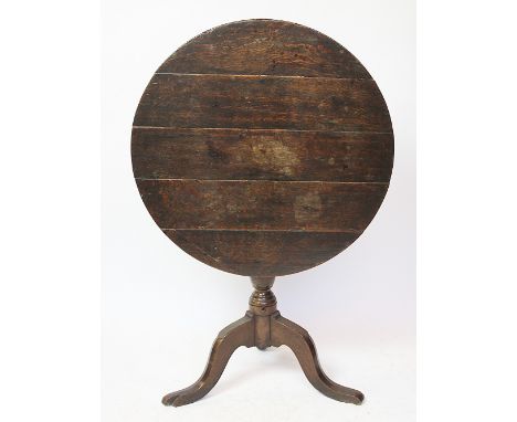 A George III oak tilt top occasional table, with five plank top, on a turned column and tripod base, 70cm H x 72cm W