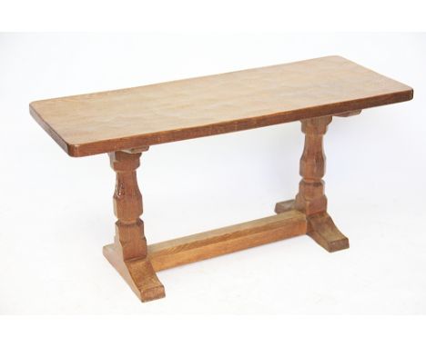 A Robert Thompson of Kilburn (Mouseman) azed oak coffee table, the rectangular top raised on a trestle base baring carved Mou