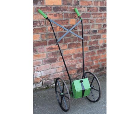 A vintage agricultural Seed drill, with painted wooden handles with an X frame support and central capsule, 127cm H
