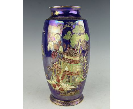 A Carlton Ware vase, decorated in gilt with a temple landscape, against an iridscent royal blue ground, black printed mark to