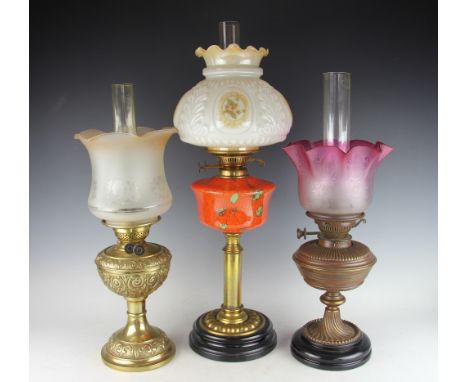 A Victorian oil lamp with brass pedestal with mottled orange and green glass reservoir, double duplex, 66cm high (at fault) a