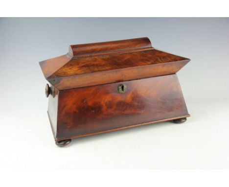 A Regency mahogany sarcophagus shaped tea caddy, with bun feet, 35cm long