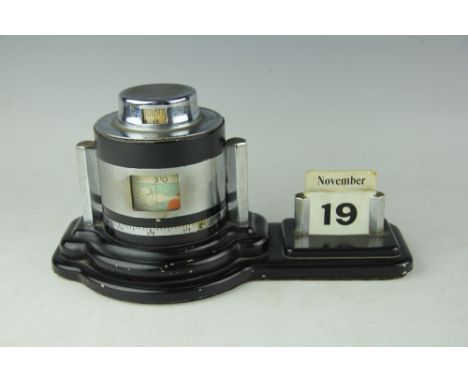 An Art Deco desk calendar and barometer, the black enamel and chrome perpetual calendar with cylinder barometer, 26.5cm wide,