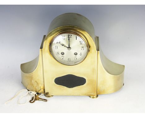 A brass cased 8 day mantle clock, 19th century, the silvered dial with black Arabic numerals, within sinuous case with foliat