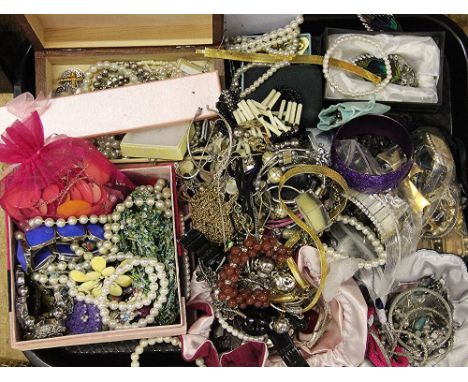 A large quantity of modern costume jewellery to include, an enamel decorated cross pendant on chain, bracelets, necklaces, ri
