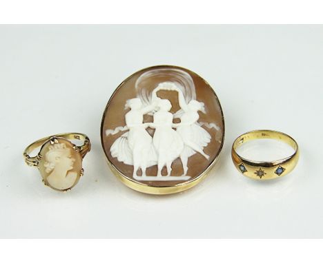 A carved shell cameo brooch depicting the three graces, within yellow metal surround, unmarked, a further cameo set ring and 