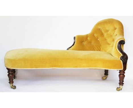 A Victorian single end chaise lounge, with mahogany frame, upholstered button back in mustard velvet, with carved scroll deta