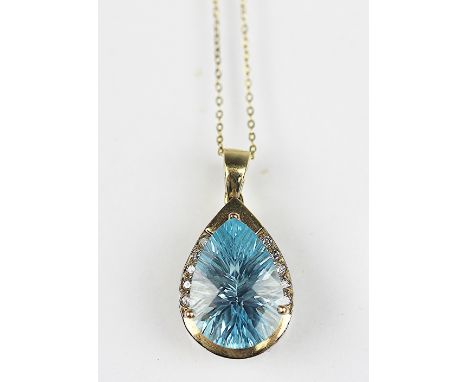 A blue topaz and diamond set pendant, the pear shaped topaz (measuring approx 15mm x 11mm) set within two rows of five brilli