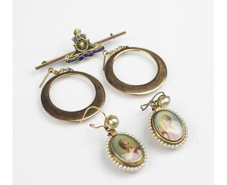 A Royal Artillery brooch, enamelled and stamped '9ct', weight 3.6gms, a pair of yellow metal hoop earrings, unmarked, weight 