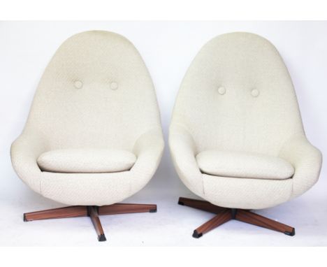 A pair of Greaves and Thomas style swivel egg shaped office chairs, upholstered with button back on four legs, 92cm highN.B. 