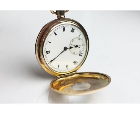 A gold plated half hunter pocket watch, the white enamel dial with black Roman numerals and subsidiary seconds dial, the fron