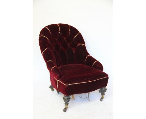 A Victorian salon chair, the button back chair with purple upholstery on two turned legs and casters, 73cm H