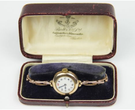A lady's 9ct gold wristwatch, probably Chester 1918, the circular dial enclosing white enamel face with black Arabic numerals