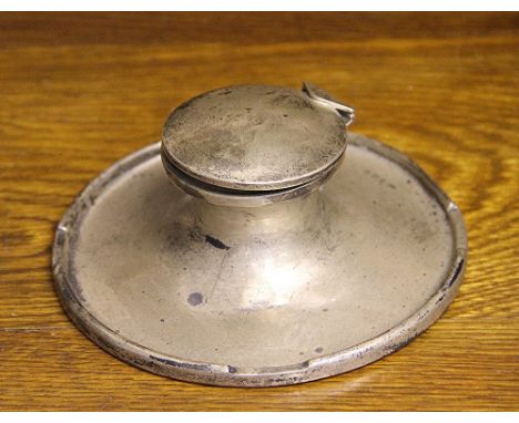 A silver capstan inkwell, A & J Zimmerman, Birmingham 1911, of typical concave form, loaded, base 15cm diameter 