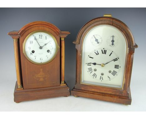A Victorian oak cased mantle clock, the domed cased enclosing a silvered dial, 34cm high, and an Edwardian eight day mantle c
