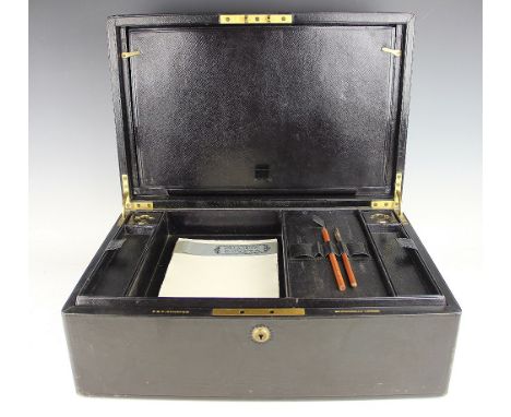 A late 19th century leather writing case, retailed by 'P & F. Schafer', the hinged cover enclosing a compartmented removable 