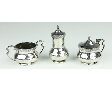 A three piece silver condiment set, with Celtic strapwork, Walker and Hall, Sheffield 1913, 9ozt