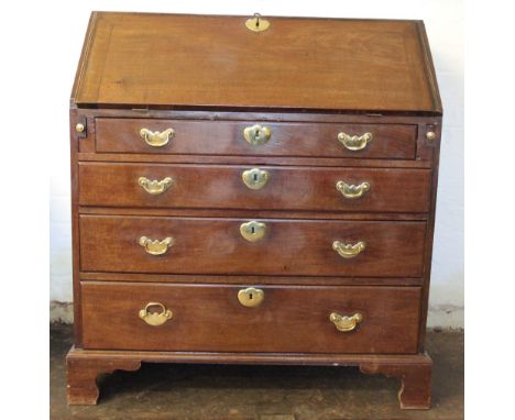 A late 19th century mahogany bureau, the drop front enclosing compartmented interior above four graduated long drawers, on og