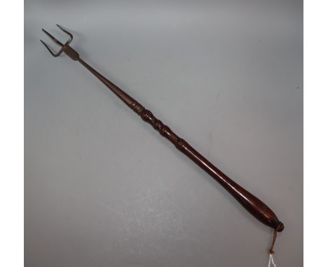 A George III bird roasting fork, with turned mahogany handle
