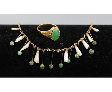 A Chinese yellow metal and jade ring, size L and a delicate gold mother of pearl and turquoise fringe necklace