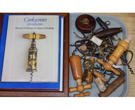A collection of 19th/20th century corkscrews and two reference books, including finger pull, simple, wood barrelled and a tip